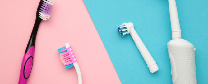 comparison image of manual and electric toothbrushes side by side