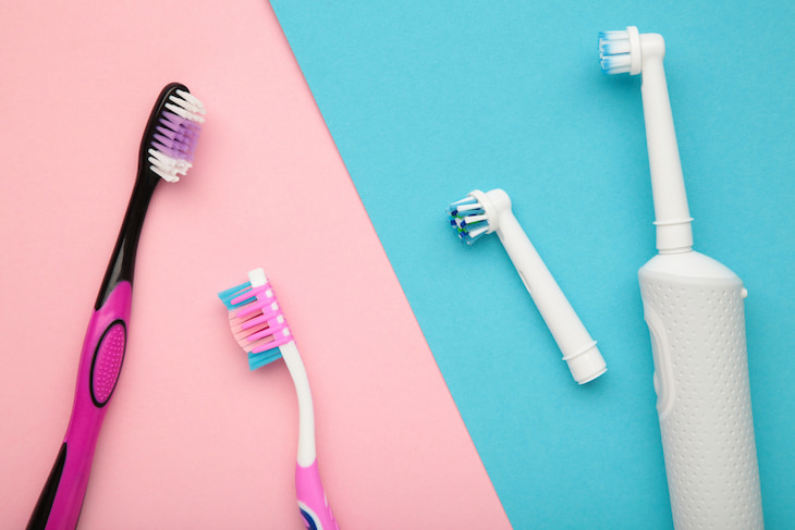 comparison image of manual and electric toothbrushes side by side