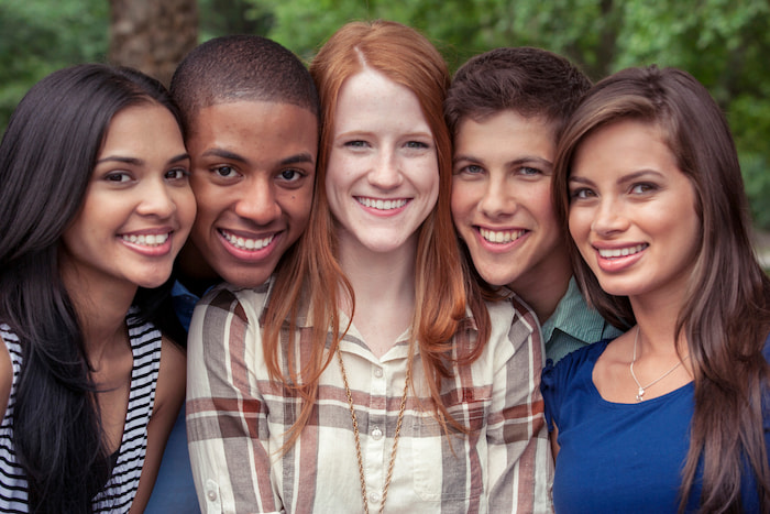 a group of smiling teenagers