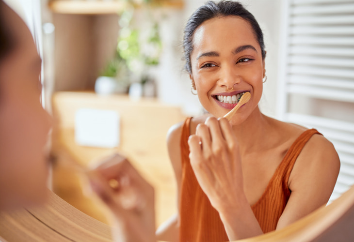 woman brushing her teeth