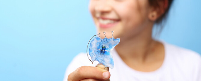 girl holding retainer