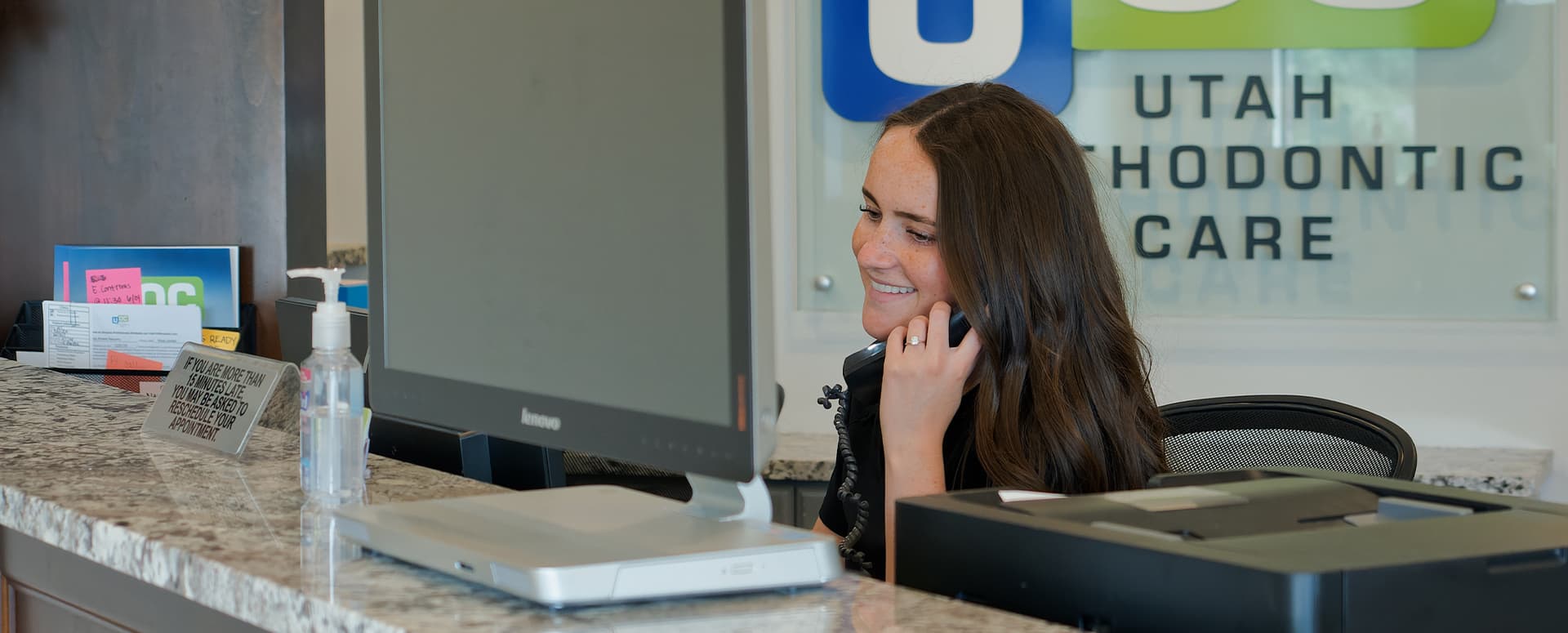 smiling employee at front desk