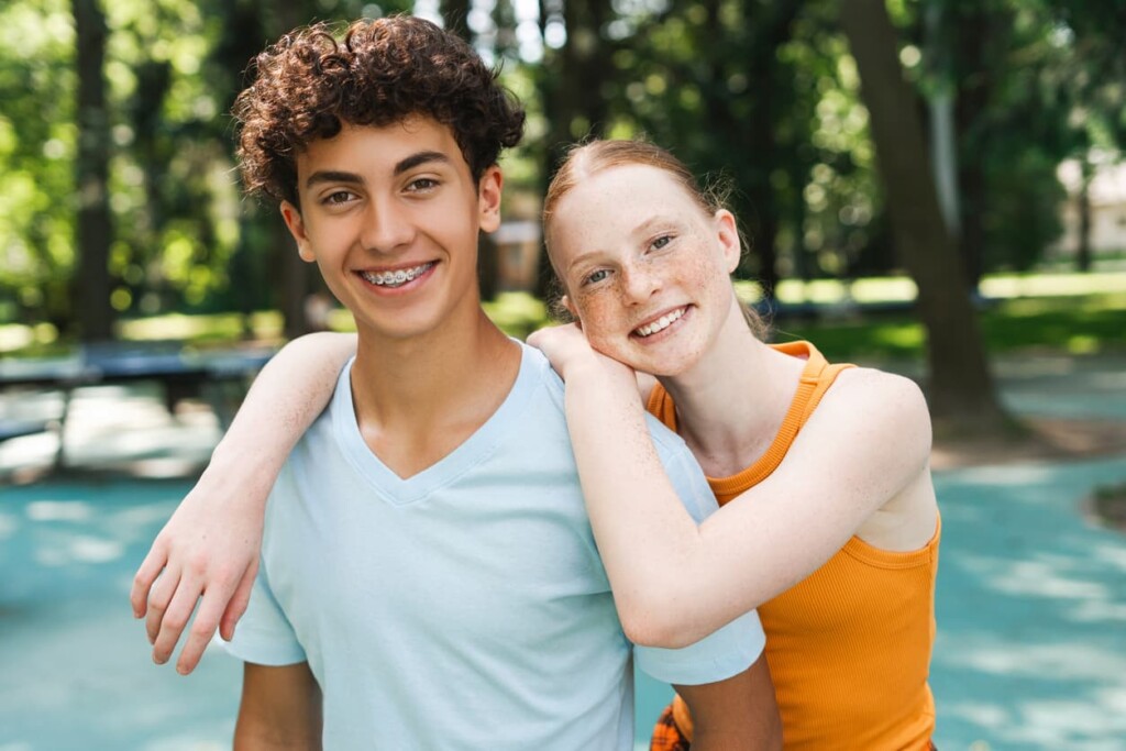teenage boy wearing braces and female friend